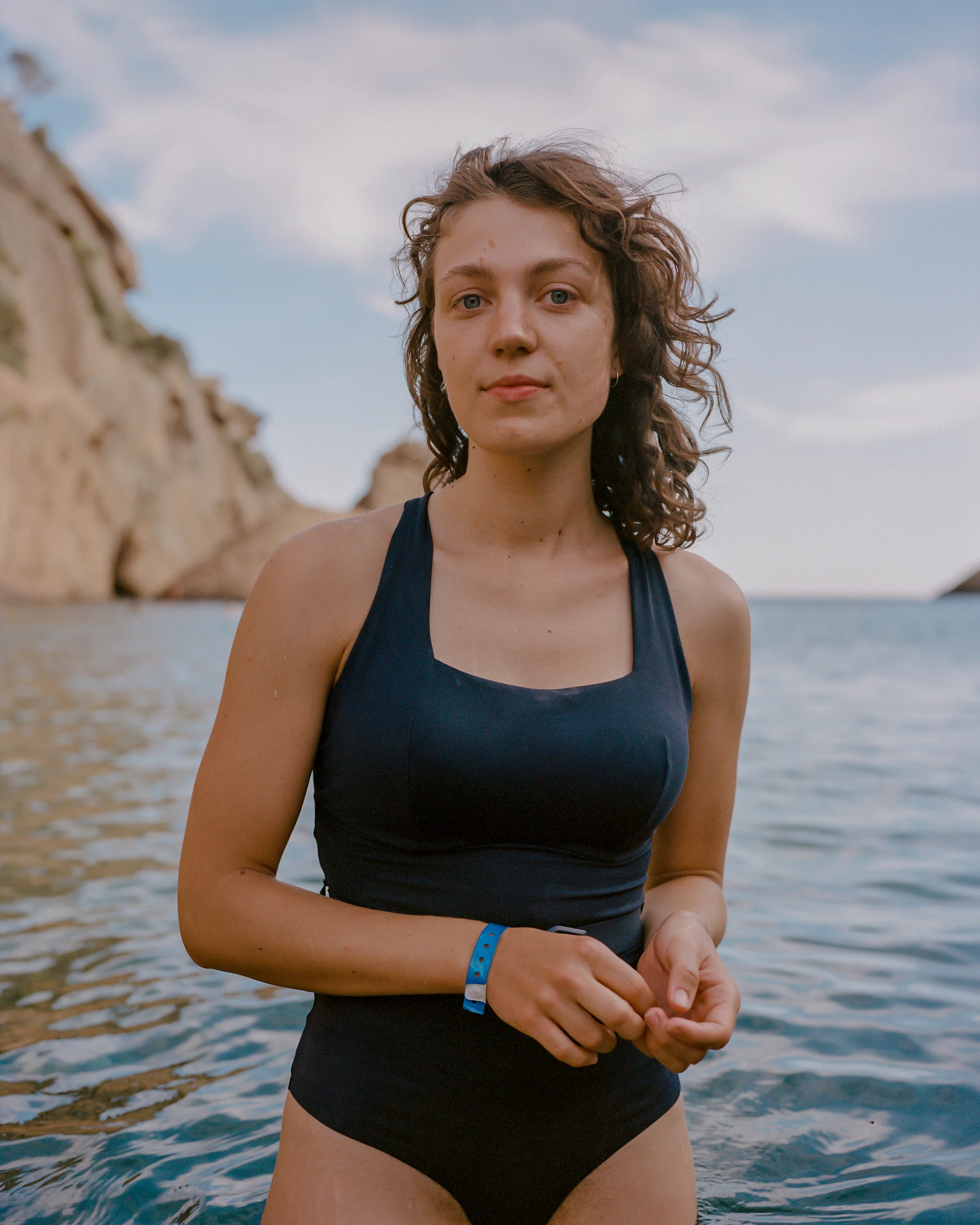 A Grow Therapy client standing by the water, mid-thought