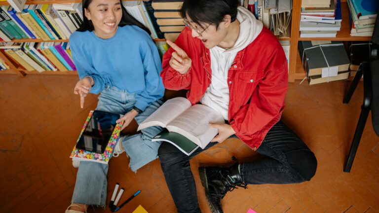 Couple sits in library.