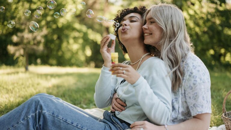 Women blowing bubbles on a date.