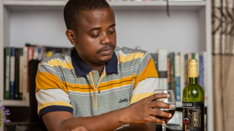 Adult and child with disabilities play on swingset.