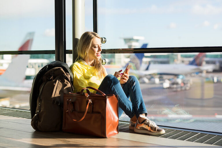 Woman sitting in an airport waiting for a flight.