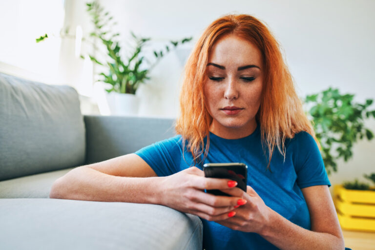 A person using a smartphone-based mental health program.