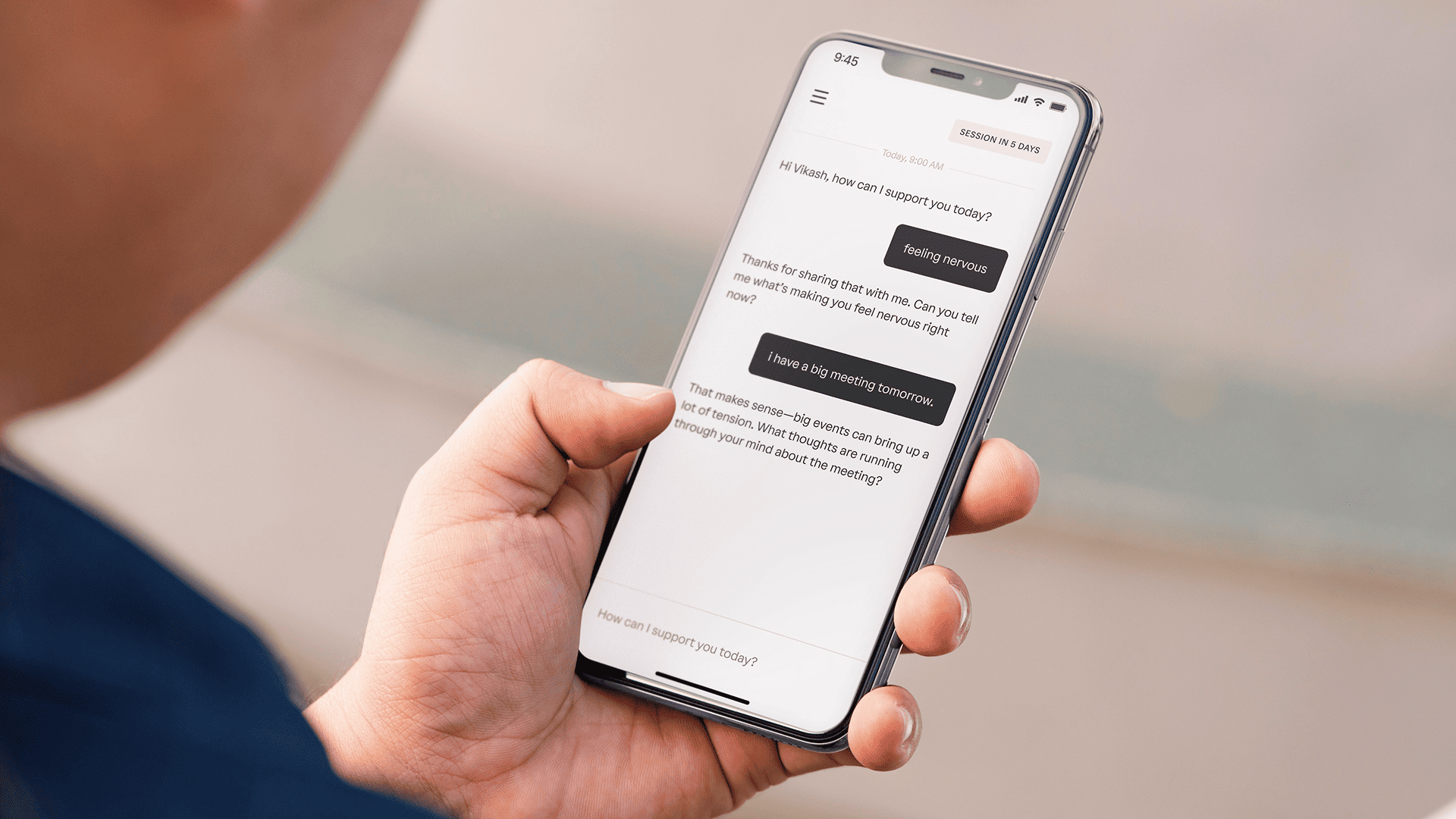 A person holds a smartphone displaying a chat conversation about feeling nervous and discussing an upcoming meeting.