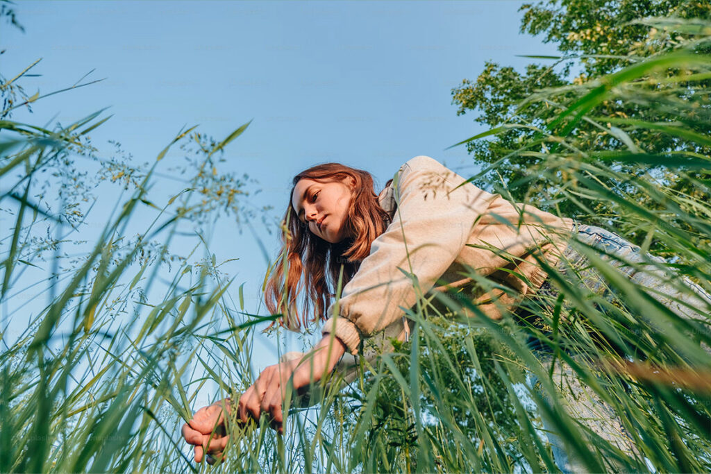A view from below of a person in a tall grass field.
