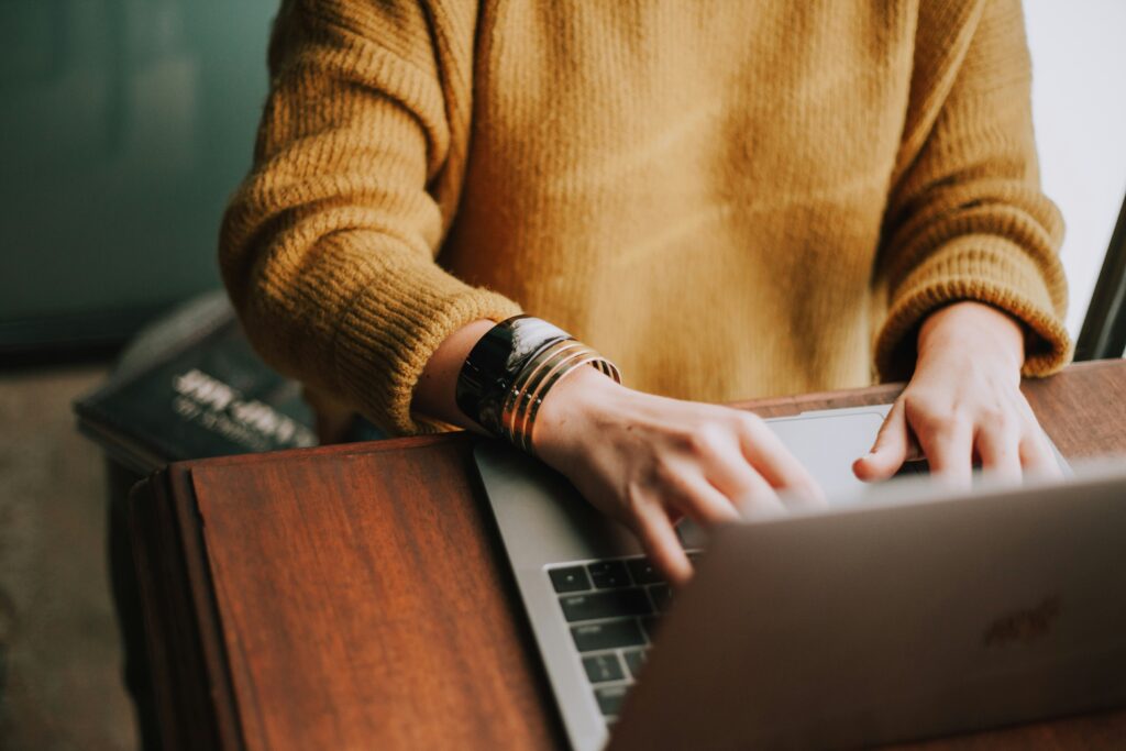 A person using a laptop to research the best online ADHD treatment.