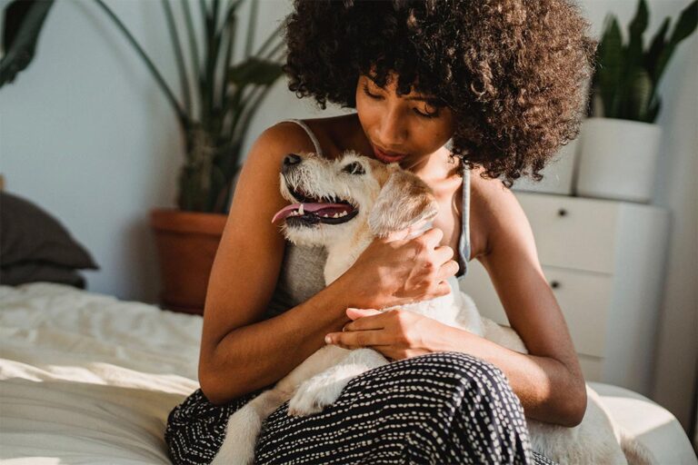 Woman hugging a dog.